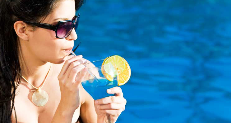 Beautiful Hispanic Latina Woman Drinking Cocktail By A Swimming